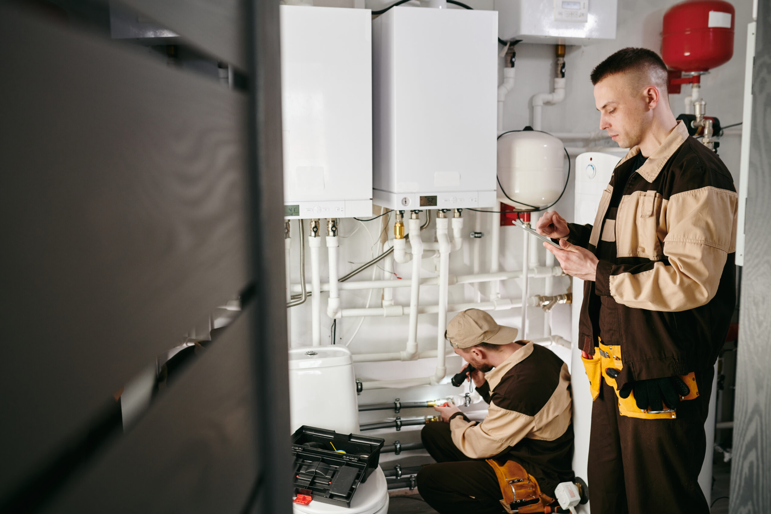 Technicians inspecting heating system equipment.