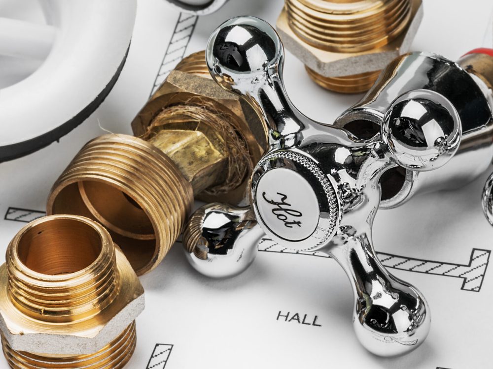 plumbing and tools lying on drawing for repair