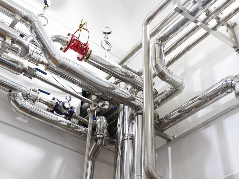 Modern industry equipment, cables and piping inside in manufacture background